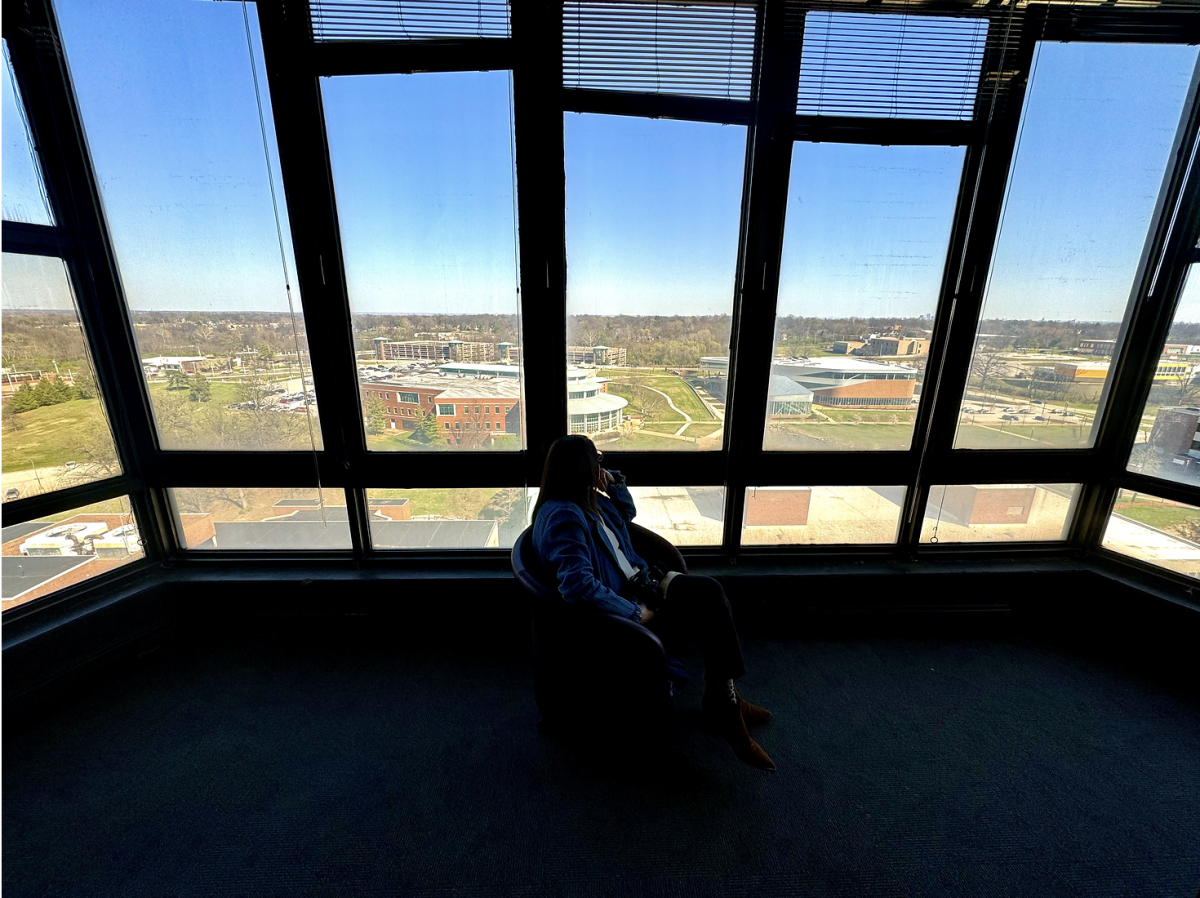 Professor Jill Alexander ponders the view from the faculty lounge located on the 13th floor of the Tower.